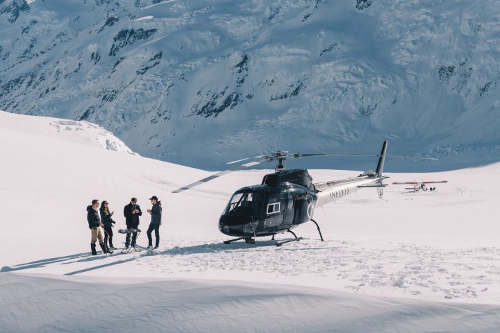 a group of people riding skis on top of a snow covered mountain