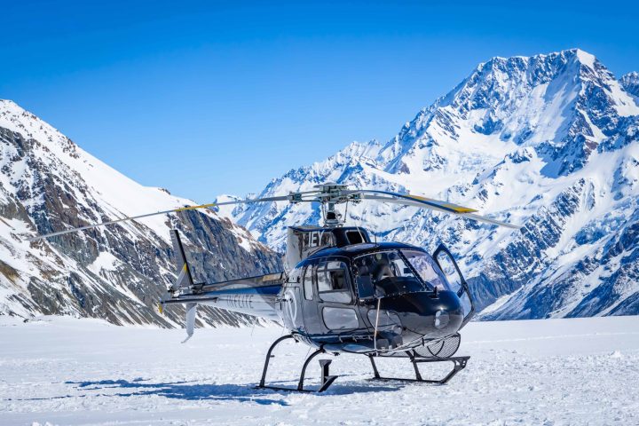 Helicopter landing on Tasman Glacier with Mountain cook in the background